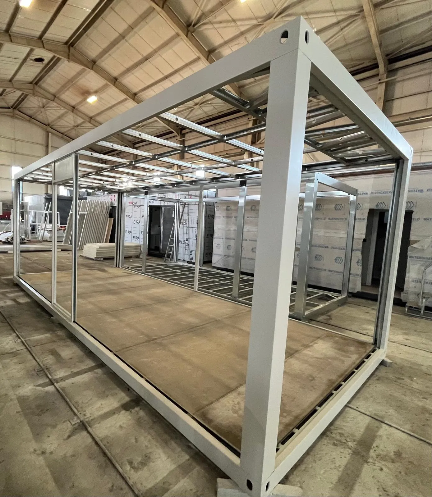 Prefabricated container system built under flat pack house assembly services supervision.
