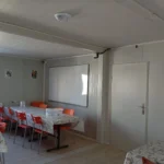 Prefabricated dining hall with kitchen and seating area