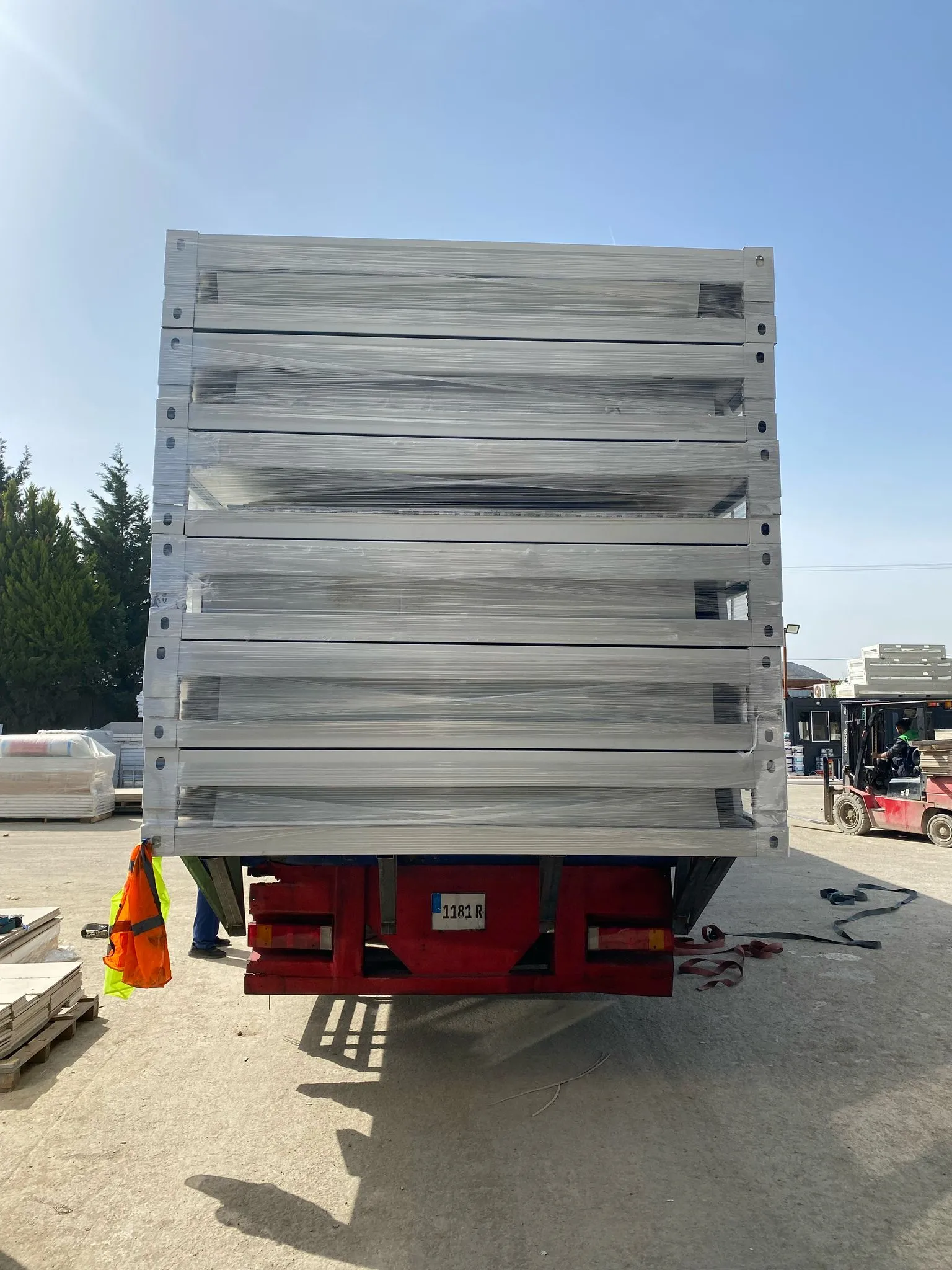 On-site workers executing flat pack house assembly services for modular buildings.