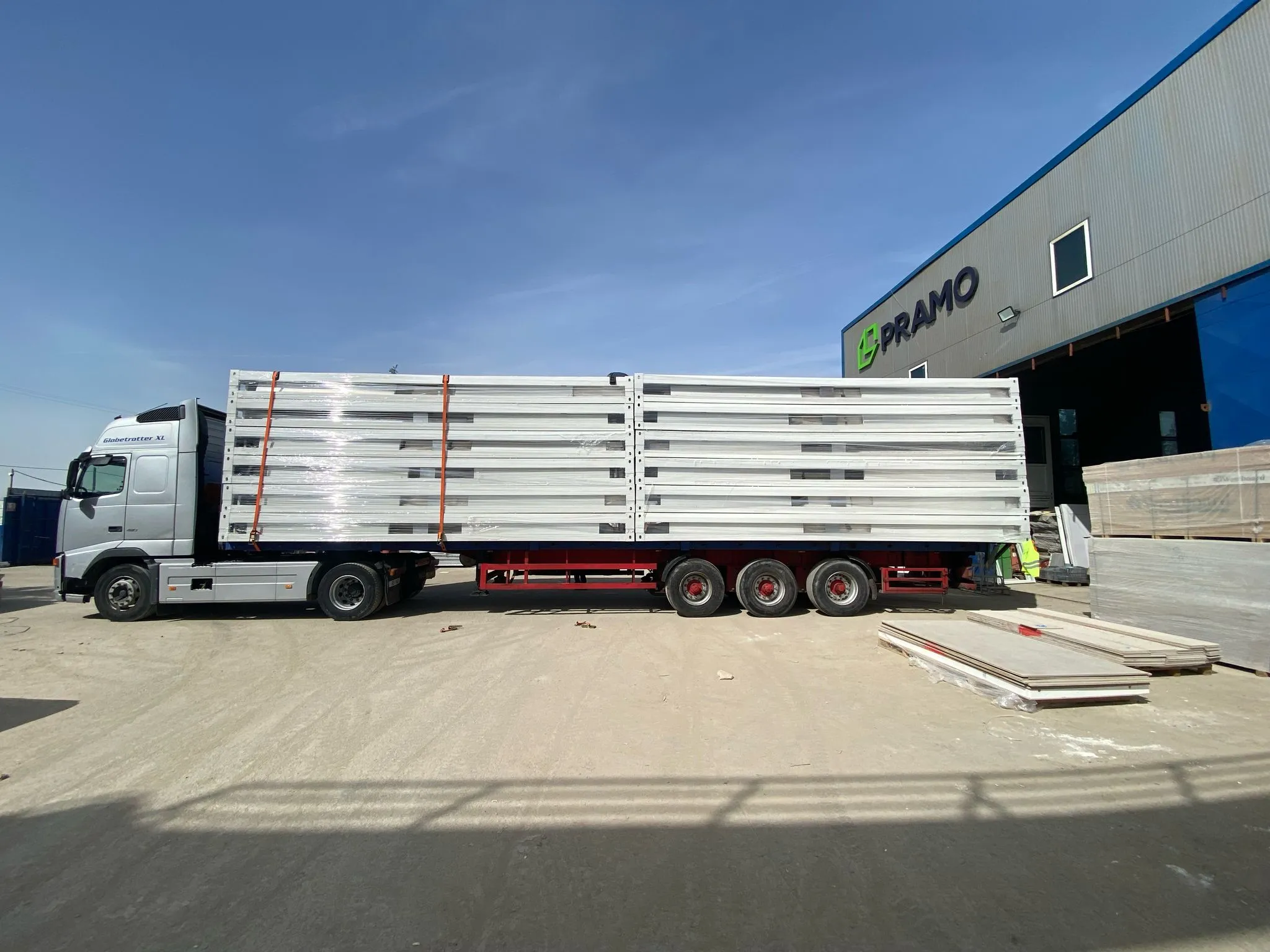 Factory view of flat pack house assembly services and prefabricated container setup.