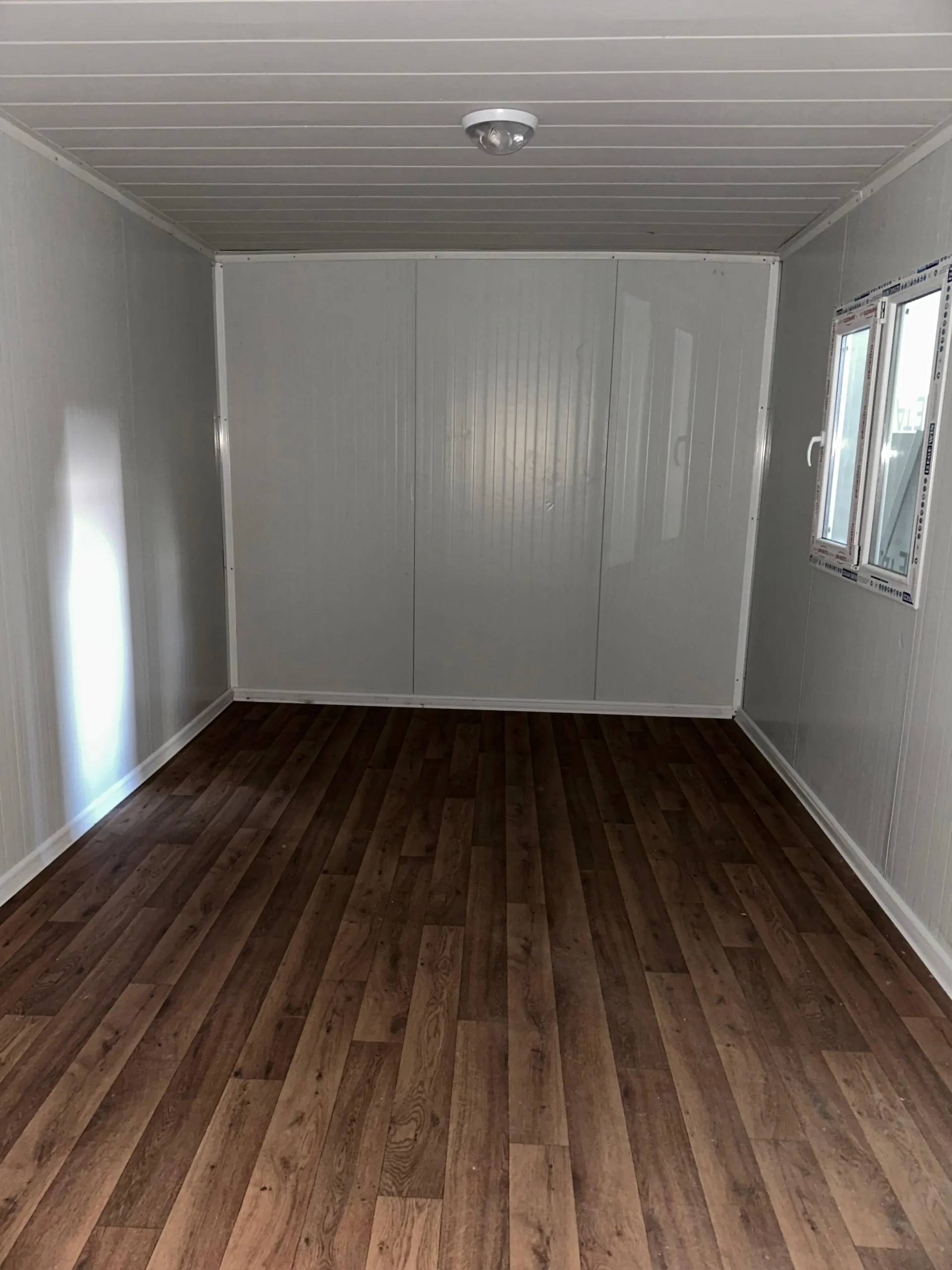 Flat pack house assembly services showcasing modular steel frame construction in factory.