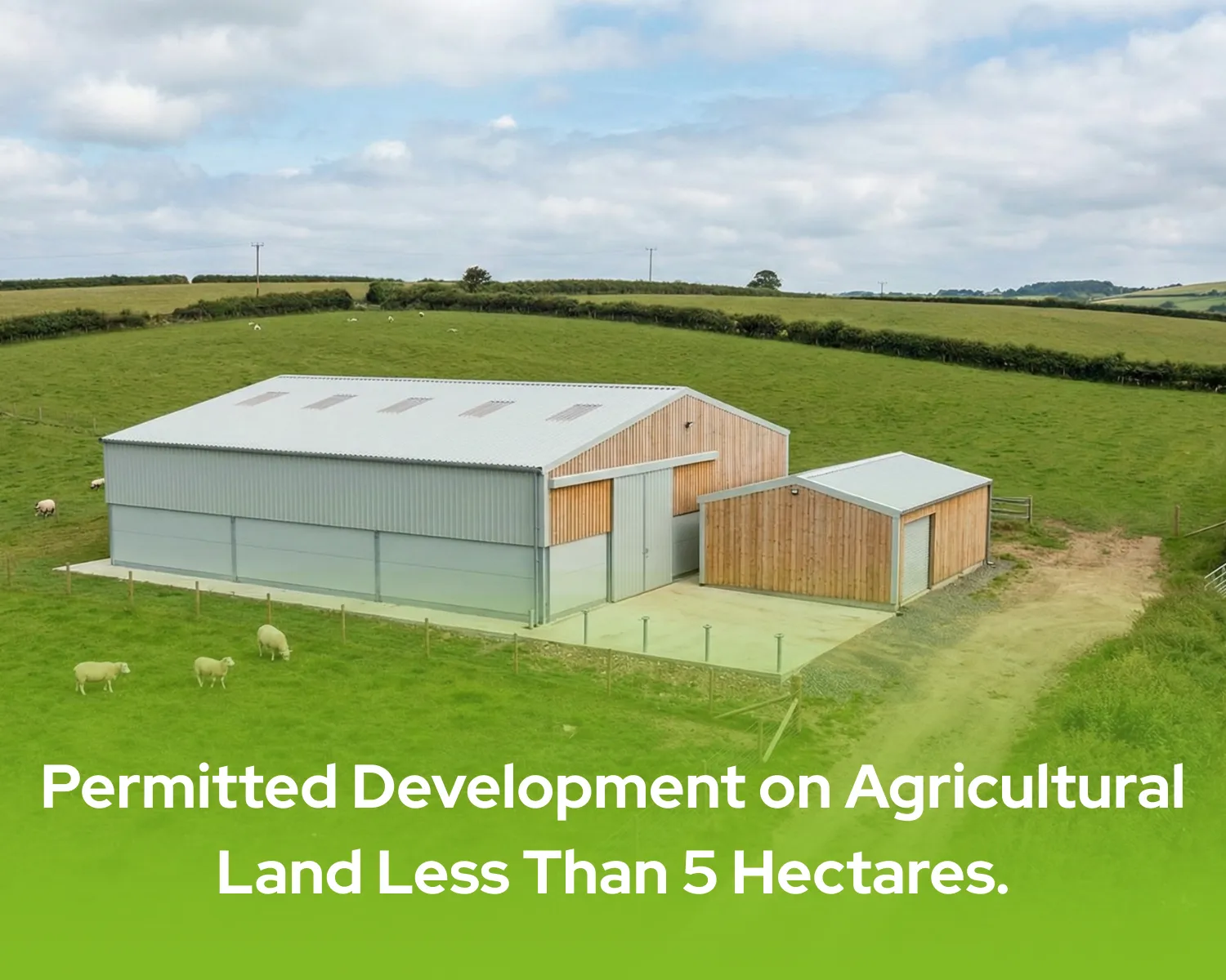 A modern light steel agricultural barn and storage shed situated on a small rural plot with sheep, illustrating permitted development on agricultural land less than 5 hectares.